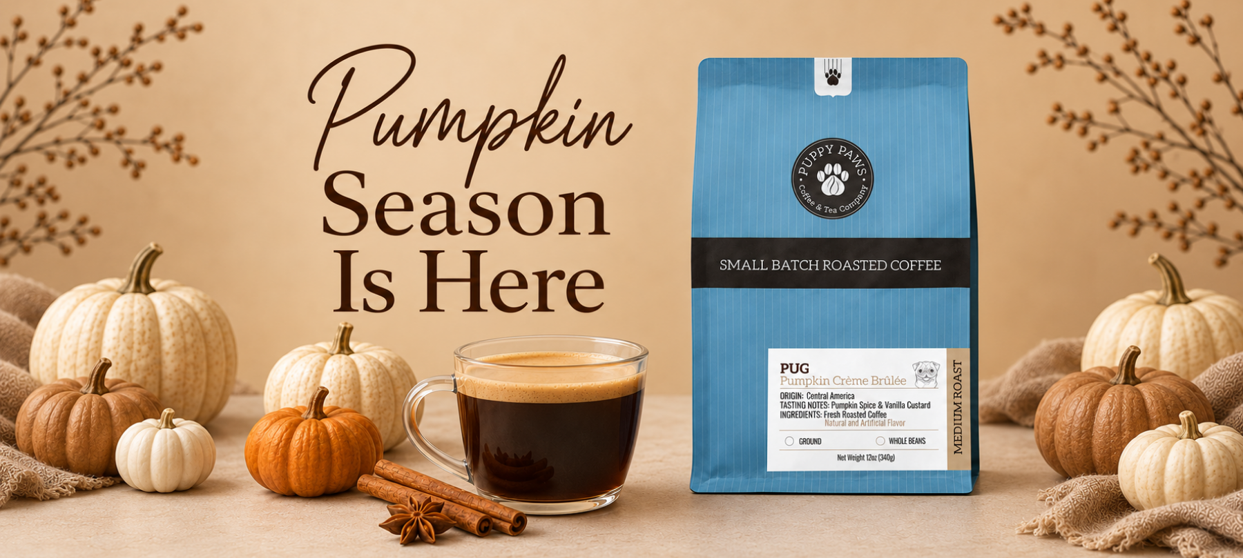 A bag of Pug Pumpkin Creme Brulee Roasted Coffee next to a glass mug of black coffee, surrounded by small pumpkins, cinnamon sticks, and autumn branches on a beige background with the text 'Pumpkin Season Is Here'.